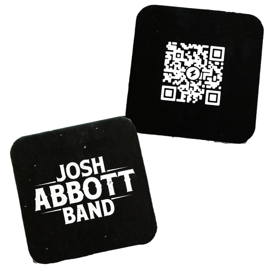 Two square coasters, one with a QR code and the other with ’JOSH ABBOTT BAND’ text.