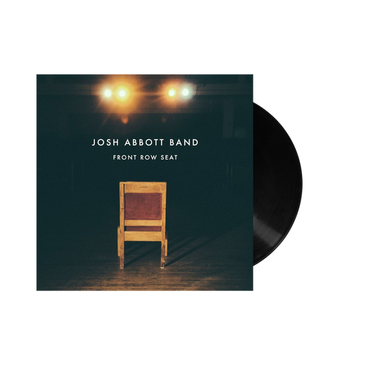 Vinyl record album cover featuring a wooden chair under spotlights.