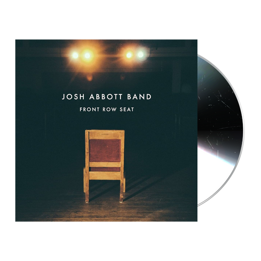 Album cover featuring a wooden chair illuminated by overhead stage lights.